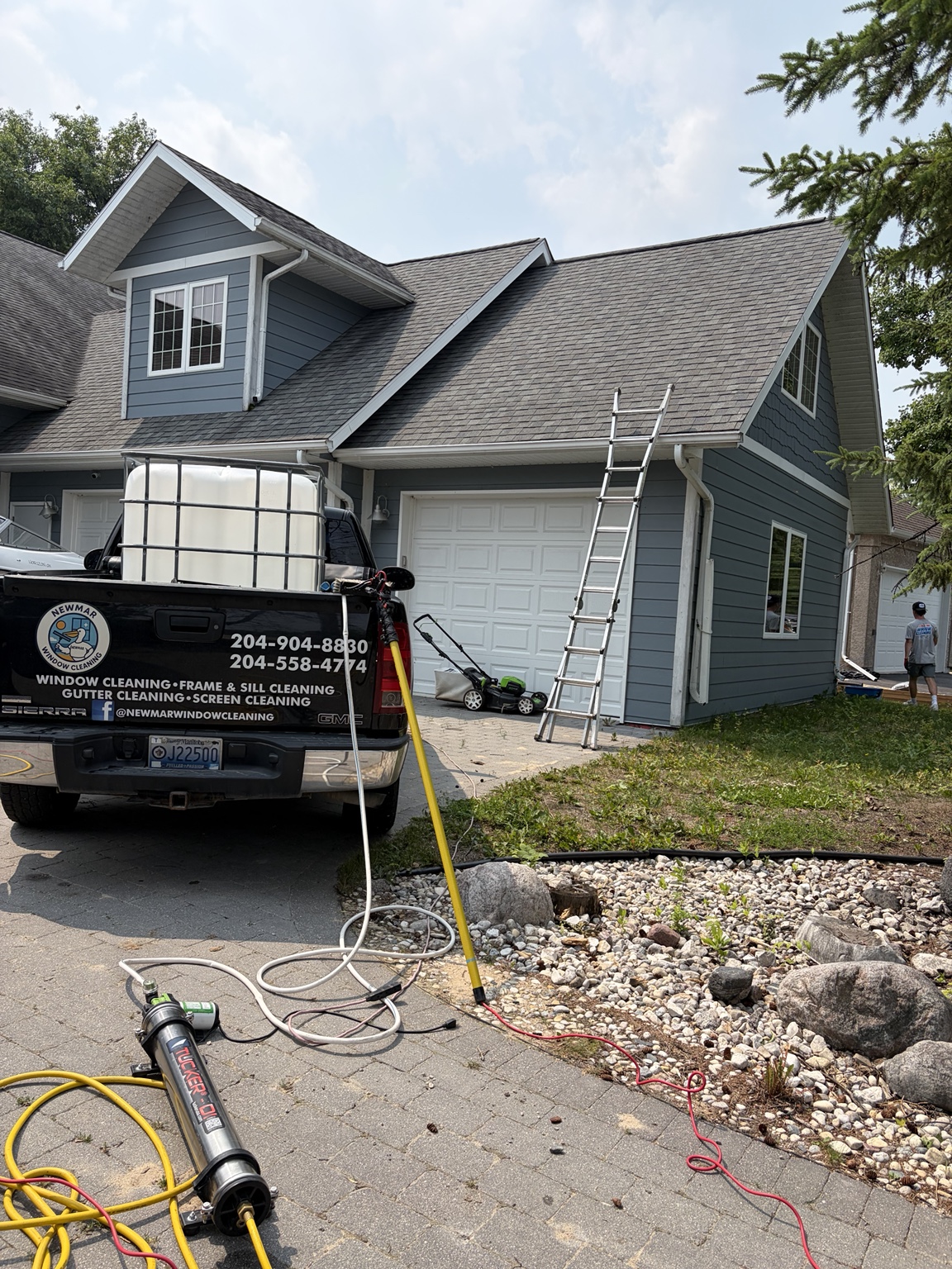 Newmar Window Cleaning truck and equipment at a job site