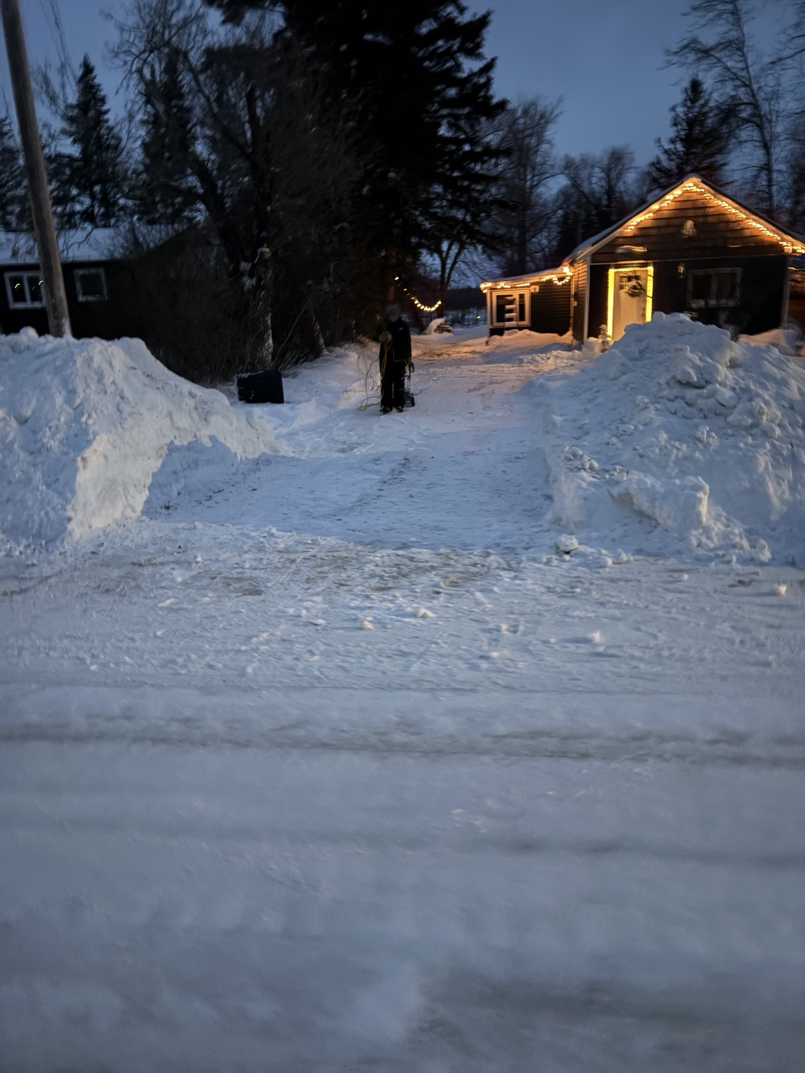 Winter exterior service photo with snow clearing and lighting